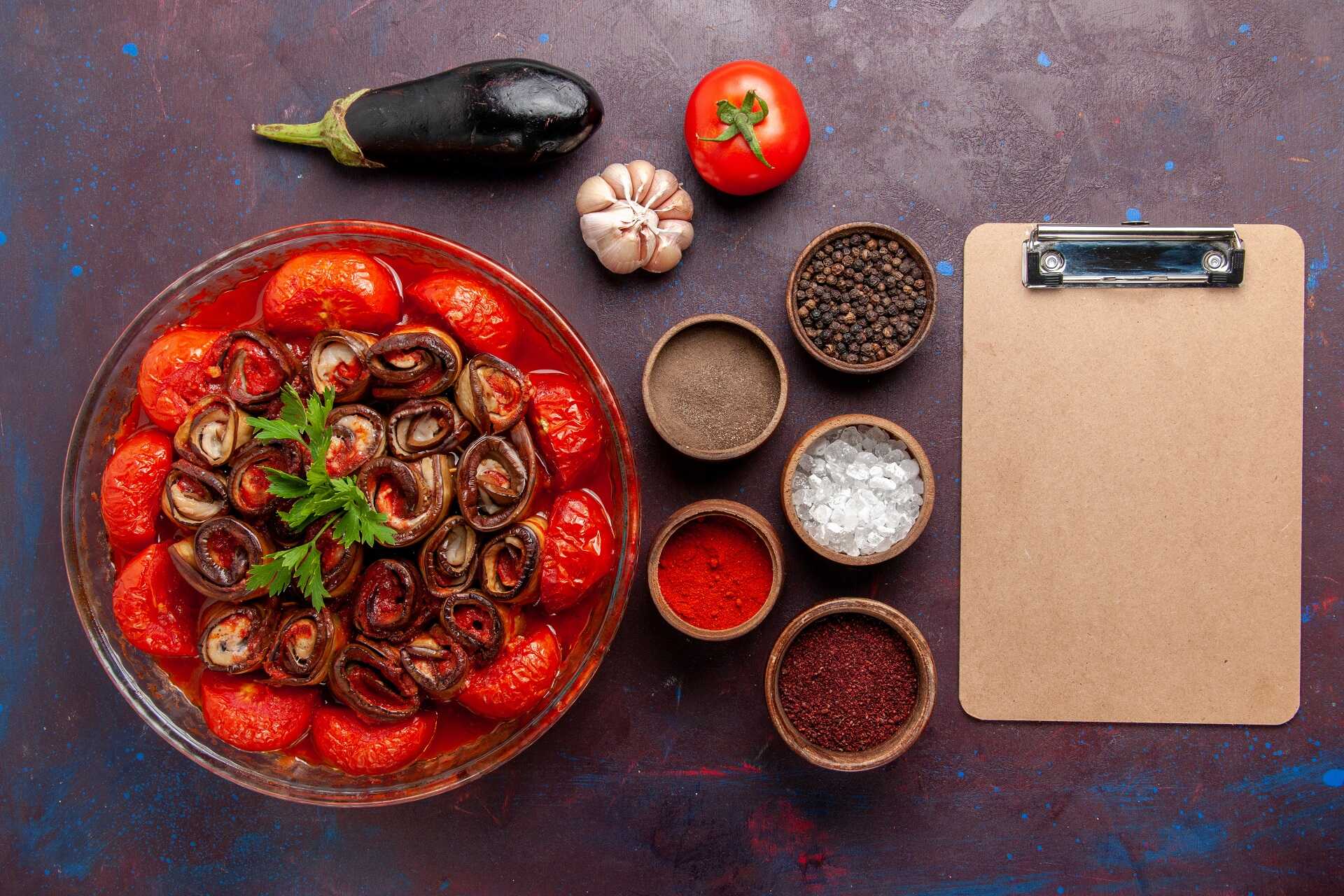 top-view-cooked-vegetable-meal-tomatoes-and-eggplants-with-seasonings-on-dark-desk_optimized
