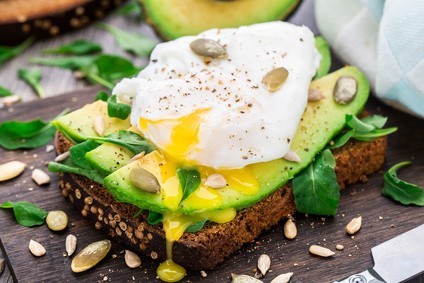Avocado sandwich with arugula, seeds and poached egg